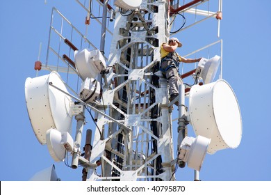 Engineer On Phone On Top Of Telecom Pylon