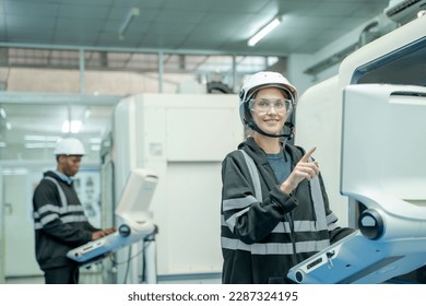 Engineer operating CNC computer machine working in industry factory.