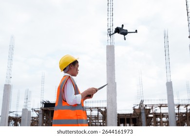 Engineer operating drone at construction site for industrial inspection and surveillance, ensuring safety, power infrastructure development, and environmental monitoring with advanced remote control t