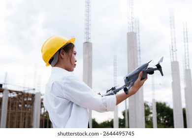 Engineer operating drone at construction site for industrial inspection and surveillance, ensuring safety, power infrastructure development, and environmental monitoring with advanced remote control t
