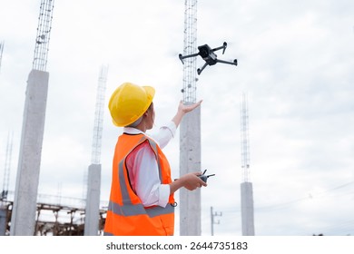 Engineer operating drone at construction site for industrial inspection and surveillance, ensuring safety, power infrastructure development, and environmental monitoring with advanced remote control t - Powered by Shutterstock - Get 15% off with code: PIKWIZARD15