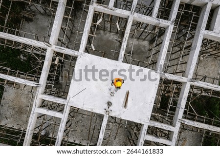 Engineer operating drone at construction site for industrial inspection and surveillance, ensuring safety, power infrastructure development, and environmental monitoring with advanced remote control t