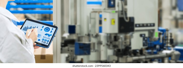 Engineer operating a machine tool with a tablet