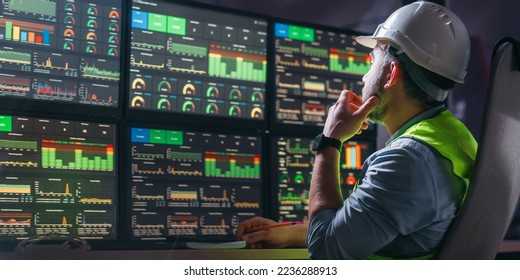 Engineer operator and computer screens with modern following production system Industry 4.0 Head engineer of factory control process production line uses UI interfaces - Shutterstock ID 2236288913