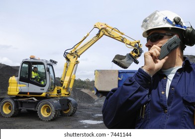 Engineer Overlooking Bulldozer, Digger And Its Driver