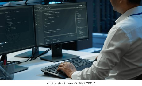 Engineer overseeing data center, making routine improvements and updates to ensure system can handle all networking tasks. Server room employee tracking network traffic and activity, camera A