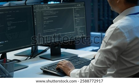 Engineer overseeing data center, making routine improvements and updates to ensure system can handle all networking tasks. Server room employee tracking network traffic and activity, camera A