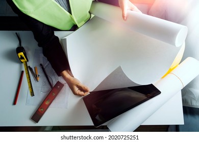 engineer people meeting working and pointing at a drawings in office for discussing. Engineering tools and construction concept. - Shutterstock ID 2020725251