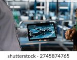 Engineer presenting defense systems to army commander in control center server hub, troubleshooting military surveillance in data center. Male soldier in command center server room.