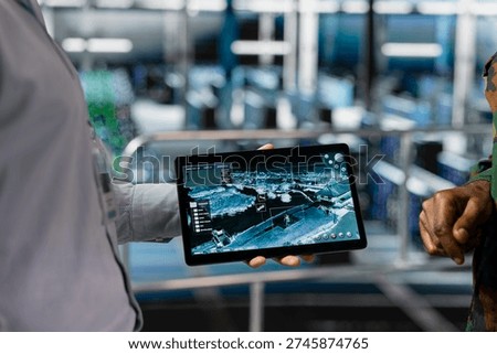 Engineer presenting defense systems to army commander in control center server hub, troubleshooting military surveillance in data center. Male soldier in command center server room.