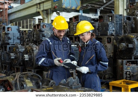 Engineer in the process of inspecting train engines Keep the machine ready for use in the train station. Engineers wear safety clothing and helmets to work safely as standard.