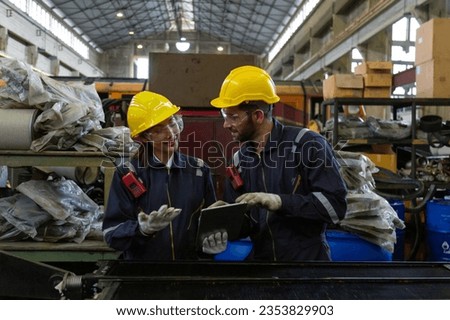 Engineer in the process of inspecting train engines Keep the machine ready for use in the train station. Engineers wear safety clothing and helmets to work safely as standard.