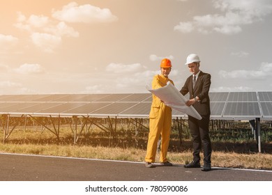engineer and project team discussing plan for construction project solar power plant 