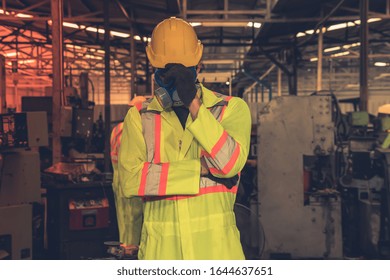 Engineer with protective mask in factory.engineer working in industrial factory.
