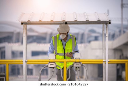 Engineer Putting Hand To Control Cost-effective Transmitter In Waste Water Treatment Pond System,check Quality Of Water ,he Wearing Face Mask And Safety Uniform In Work.