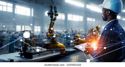 An engineer remotely controlling a robot with a tablet in a futuristic factory