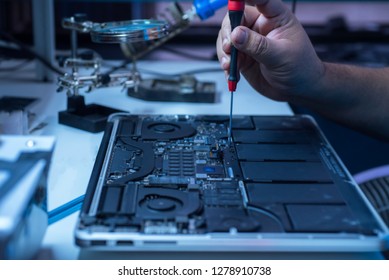 The Engineer Repairs The Laptop And The Motherboard.
