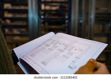 Engineer reviewing electrical plans of an industrial facility.