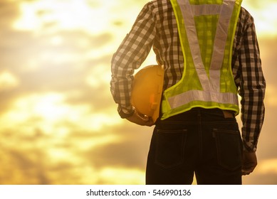 Engineer Or Safety Officer Holding Hard Hat  In Construction Site.