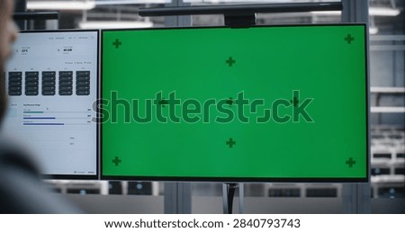IT Engineer Seated in Technical Operations Room, Examining Blank Customizable Monitor While Overseeing Enterprise Systems, Hardware Status, Digital Workflows, and Routine Technology Diagnostics.
