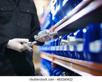 Engineer selecting bolts from store in engineering factory, close up
