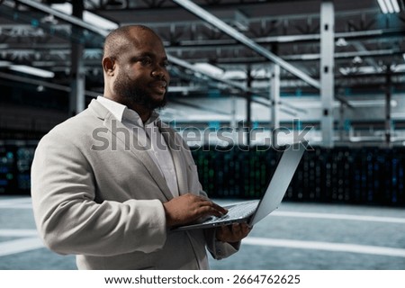 Engineer in server farm auditing systems for vulnerabilities, checking recovery plan. Data center IT specialist troubleshooting connectivity issues, making sure rigs are functioning optimally