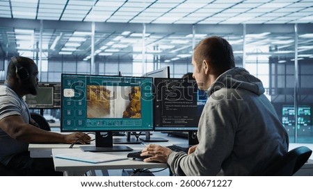 Engineer in server hub making generative artificial intelligence website generating videos using diffusion model algorithms. Employee coding AI virtual assistant producing clips, camera B