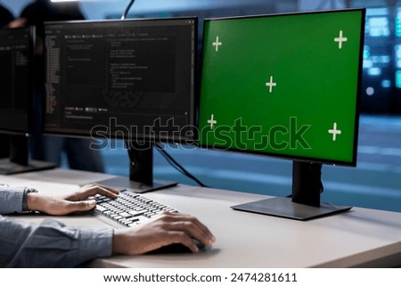 Engineer in server hub using green screen PC to repair equipment storing datasets. Professional using mockup computer to do debugging on rigs doing computational operations