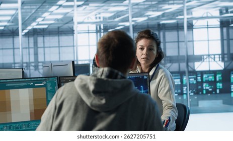 Engineer in server room chitchatting with colleague while making AI generating videos software. IT employee and coworker talking while building artificial intelligence diffusion model app, camera A