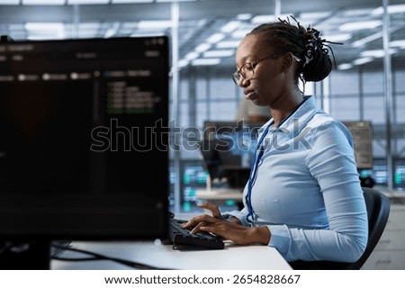 Engineer in server room ensuring compliance with industry standards and regulatory requirements. Data center employee conducting security audits to protect against cyber threats
