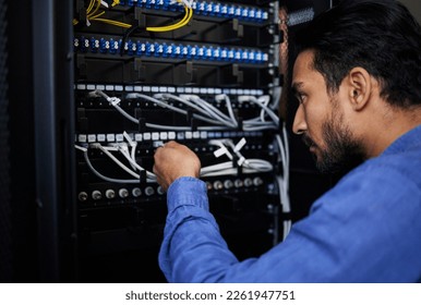 Engineer, server room and man with cable connection for software update or maintenance at night. Information technology wire, cloud computing and male programmer check database network in data center