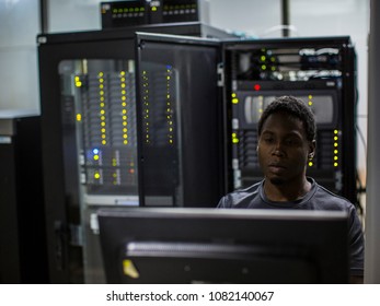 Engineer i the server room working on the terminal