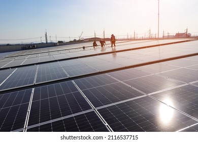 Engineer and service man installation solar cell on the roof of the factory, solar farm energy, renewable energy - Shutterstock ID 2116537715