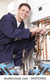 Engineer Servicing Central Heating Boiler