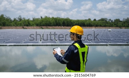 Engineer setting up floating solar panels on a platform in the lake. Worker is on-site, installing and maintaining the floating solar panel system on the water.