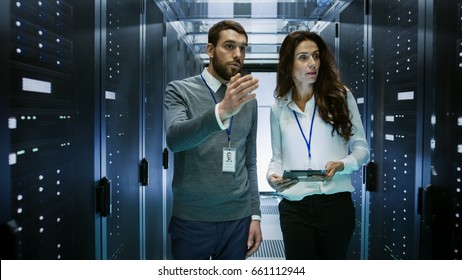 IT Engineer Shows Working Data Center / Server Room to Female Chief Engineer who Holds Tablet Computer.