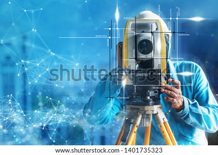 engineer site survey with laser tripod machine in site construction background