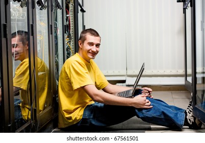 The engineer sits in data - center and configuring equipment.