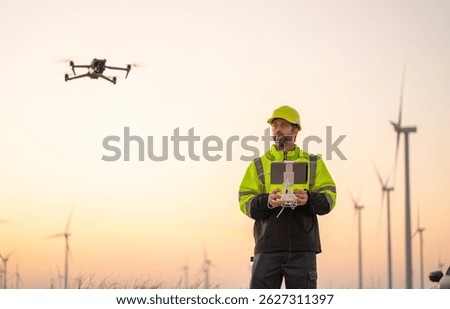 Engineer Specialists Pilot Drone on Wind Turbine Farm. Architectural Engineer and Safety Engineering Inspector Fly Drone at industrial plant.