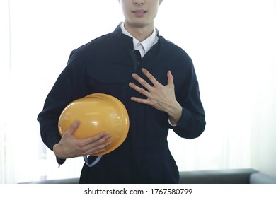 Engineer standing with hardhat in office