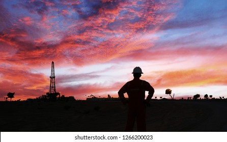 An Engineer Is Standing In The Oilfield During Sunset In The Oman 