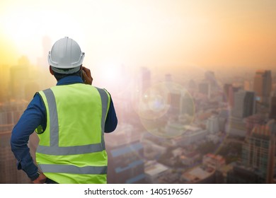 The engineer standing orders for construction crews to work on blurred cityscape background. Industry and safety ideas concept. - Shutterstock ID 1405196567