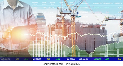 Engineer standing using tablet control and manage work at construction site.