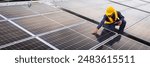 An engineer stands on a modern rooftop, inspecting an array of solar panels. The setting sun casts a warm glow, highlighting the commitment to renewable energy and technological advancement.