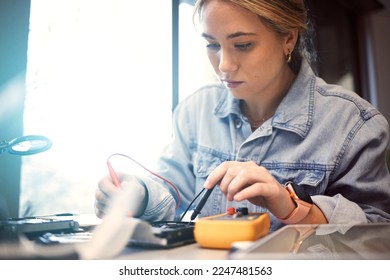 Engineer, student and woman repair electronics for science project. Learning, education and female technician with technology testing microchip, gadget or circuits for electricity with electric meter - Powered by Shutterstock