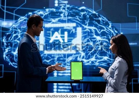 Engineer and supervisor use AI machine learning to extract information from complex data on isolated screen tablet. Experts in workspace use artificial intelligence technology on chroma key device