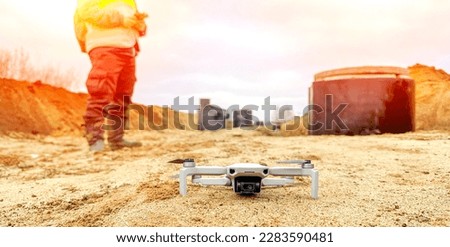engineer surveyor builder with quadrocopter on the construction site. High quality photo
