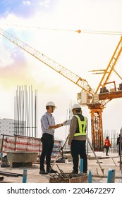 Engineer And Surveyor Worker Working With Theodolite Transit Equipment At Outdoors Construction Site.