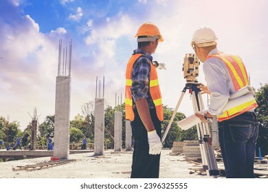 Engineer or surveyor worker working with theodolite transit equipment at outdoors construction site. Selected focus