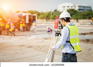 engineer surveyor working with theodolite at construction site - Shutterstock ID 621830984